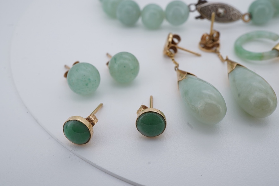 A collection of jadeite jewels, comprising: a bead bracelet with a silver clasp; together with three pairs of studs; one pair of hoop studs, one broken and restuck; and one pair of drop earrings, each set with jadeite, m